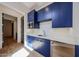 Wet bar with custom blue cabinets and stainless appliances at 1538 W Wagon Wheel Dr, Phoenix, AZ 85021