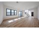 Spacious living room with natural light, hardwood floors, staircase, and modern windows at 1538 W Wagon Wheel Dr, Phoenix, AZ 85021