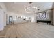 Spacious living area with modern lighting, fireplace, and open kitchen layout at 1538 W Wagon Wheel Dr, Phoenix, AZ 85021