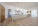 Open concept living room and kitchen with hardwood floors and modern lighting fixtures at 1538 W Wagon Wheel Dr, Phoenix, AZ 85021