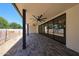 Large covered patio features brick pavers, ceiling fans, and a view of the backyard at 1538 W Wagon Wheel Dr, Phoenix, AZ 85021