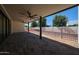 Covered patio boasts brick pavers, a ceiling fan, and views of a block-fenced yard at 1538 W Wagon Wheel Dr, Phoenix, AZ 85021