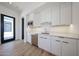 Modern wet bar features white cabinets, quartz counters, stainless steel sink, and beverage cooler at 1538 W Wagon Wheel Dr, Phoenix, AZ 85021
