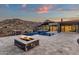 An inviting backyard featuring a pool, fire pit, and stunning views of the mountains beyond at 16119 N Desert Fox Pkwy, Fountain Hills, AZ 85268