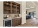 Stylish bar area with custom cabinetry, marble countertops, and a convenient wine cooler at 16119 N Desert Fox Pkwy, Fountain Hills, AZ 85268