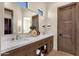 Luxurious bathroom with dual sinks, marble countertops, a large mirror, and a doorway to a walk-in closet at 16119 N Desert Fox Pkwy, Fountain Hills, AZ 85268