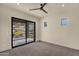 An empty bedroom with carpet flooring features a sliding glass door to the outside and mountain views at 16119 N Desert Fox Pkwy, Fountain Hills, AZ 85268