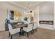 Elegant dining room featuring a modern chandelier, fireplace, and stylish decor at 16119 N Desert Fox Pkwy, Fountain Hills, AZ 85268
