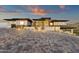 Contemporary home with a grand paver driveway and modern front entrance featuring stone accents and landscape lighting at 16119 N Desert Fox Pkwy, Fountain Hills, AZ 85268