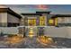 Elegant entry showcasing stone steps, meticulous landscaping, and warm lighting leading to a modern front door at 16119 N Desert Fox Pkwy, Fountain Hills, AZ 85268