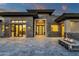 Modern home featuring a stylish front entrance, stone accents, and a welcoming outdoor fire pit for cozy gatherings at 16119 N Desert Fox Pkwy, Fountain Hills, AZ 85268