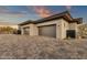 An exterior view of a 3 car garage with stone driveway pavers and modern architecture at 16119 N Desert Fox Pkwy, Fountain Hills, AZ 85268