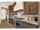 Gourmet kitchen featuring stainless steel appliances, custom cabinetry, and marble countertops at 16119 N Desert Fox Pkwy, Fountain Hills, AZ 85268