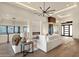 Bright living room with stylish furniture, a fireplace, and an adjacent glass-enclosed wine cellar at 16119 N Desert Fox Pkwy, Fountain Hills, AZ 85268