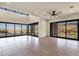 Open living room with large windows showcasing views, featuring tile flooring, and a ceiling fan at 16119 N Desert Fox Pkwy, Fountain Hills, AZ 85268