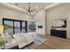 Bright primary bedroom featuring a fireplace and expansive views through sliding glass doors at 16119 N Desert Fox Pkwy, Fountain Hills, AZ 85268