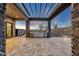 This home features a large travertine tiled patio with an outdoor kitchen at 16119 N Desert Fox Pkwy, Fountain Hills, AZ 85268