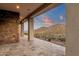 Covered patio with stone accents showcasing a beautiful view of the surrounding desert landscape at 16119 N Desert Fox Pkwy, Fountain Hills, AZ 85268