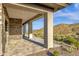 Covered patio with stone accents and mountain views offers a tranquil outdoor experience at 16119 N Desert Fox Pkwy, Fountain Hills, AZ 85268