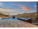 This home features a pool, spa, firepit, travertine tile patio, and mountain views at 16119 N Desert Fox Pkwy, Fountain Hills, AZ 85268