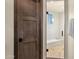 New frameless glass shower features stone pebble flooring and white tiled walls, with a wooden door nearby at 16119 N Desert Fox Pkwy, Fountain Hills, AZ 85268