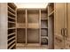 Large walk-in closet features built-in wood shelving and storage drawers on both sides of the room at 16119 N Desert Fox Pkwy, Fountain Hills, AZ 85268