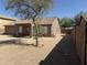 View of covered patio area, privacy wall, and low-maintenance landscaping at 1930 W Burgess Ln, Phoenix, AZ 85041