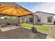 Backyard with a covered patio, beautiful pavers and barbecue at 19664 W Woodlands Ave, Buckeye, AZ 85326