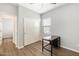 Bedroom with modern desk, closet, wood floors, and bright natural light at 19664 W Woodlands Ave, Buckeye, AZ 85326