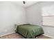 Cozy bedroom features a comfortable bed, wood floors and a ceiling fan at 19664 W Woodlands Ave, Buckeye, AZ 85326