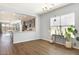 Bright dining area with hardwood floors, large windows, and a view of the open kitchen at 19664 W Woodlands Ave, Buckeye, AZ 85326