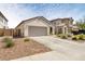 Exterior view of a single Gathering home featuring a large driveway at 19664 W Woodlands Ave, Buckeye, AZ 85326