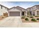Charming single-Gathering home with a spacious driveway and lush landscaping at 19664 W Woodlands Ave, Buckeye, AZ 85326