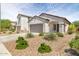Charming single-story home featuring a low-maintenance desert landscape and a two car garage at 19664 W Woodlands Ave, Buckeye, AZ 85326