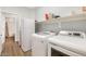 Laundry room featuring white washer and dryer and access to bathroom at 19664 W Woodlands Ave, Buckeye, AZ 85326
