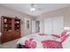 Bedroom featuring ceiling fan, large window, and an armoire at 19722 N Regents Park Dr, Surprise, AZ 85387