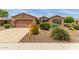 Charming single-story home with desert landscaping, a two-car garage and a 'Coming Soon' sign in the front yard at 19722 N Regents Park Dr, Surprise, AZ 85387