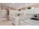 Modern kitchen with white cabinets, quartz countertops, stainless steel appliances, and a center island at 19722 N Regents Park Dr, Surprise, AZ 85387
