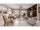 Bright living room featuring neutral decor, tile floors, large windows with views, and a built-in media center at 19722 N Regents Park Dr, Surprise, AZ 85387