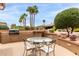 Charming outdoor patio features a built-in BBQ and ornate table with seating at 19722 N Regents Park Dr, Surprise, AZ 85387
