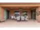 Covered patio with ample seating, perfect for outdoor dining and entertaining at 19722 N Regents Park Dr, Surprise, AZ 85387
