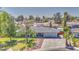 Aerial view of a home with a well-manicured lawn, mature trees and inground pool at 2046 E Downing St, Mesa, AZ 85213