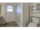 Close-up of shower, toilet, and exterior door in the bathroom at 2046 E Downing St, Mesa, AZ 85213
