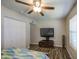 Bedroom featuring a ceiling fan, TV, and double-door closet at 2046 E Downing St, Mesa, AZ 85213