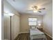 Comfortable bedroom with a ceiling fan, wood-look floors, and closet for ample storage at 2046 E Downing St, Mesa, AZ 85213