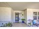 Inviting front porch featuring neutral colors, a security screen door, and cozy seating area at 2046 E Downing St, Mesa, AZ 85213