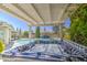Inviting hot tub under a pergola, with a pool and patio furniture in the background at 2046 E Downing St, Mesa, AZ 85213