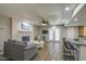 Comfortable living room boasts a painted brick fireplace, wood look floors and neutral decor with great natural light at 2046 E Downing St, Mesa, AZ 85213