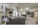 Bright and open living room featuring a modern kitchen and a cozy fireplace with white brick surround at 2046 E Downing St, Mesa, AZ 85213