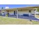 Covered patio area with access to the backyard, featuring a door and window at 2046 E Downing St, Mesa, AZ 85213